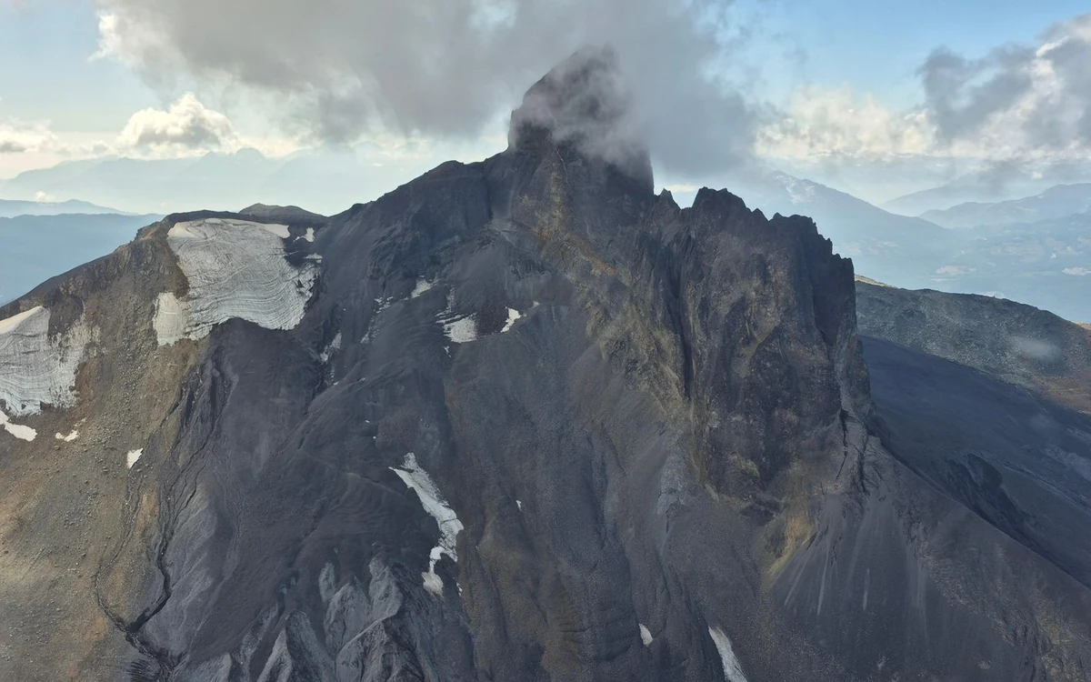 The dark volcanic spire of Black Tusk rising out of a ridge under cloud